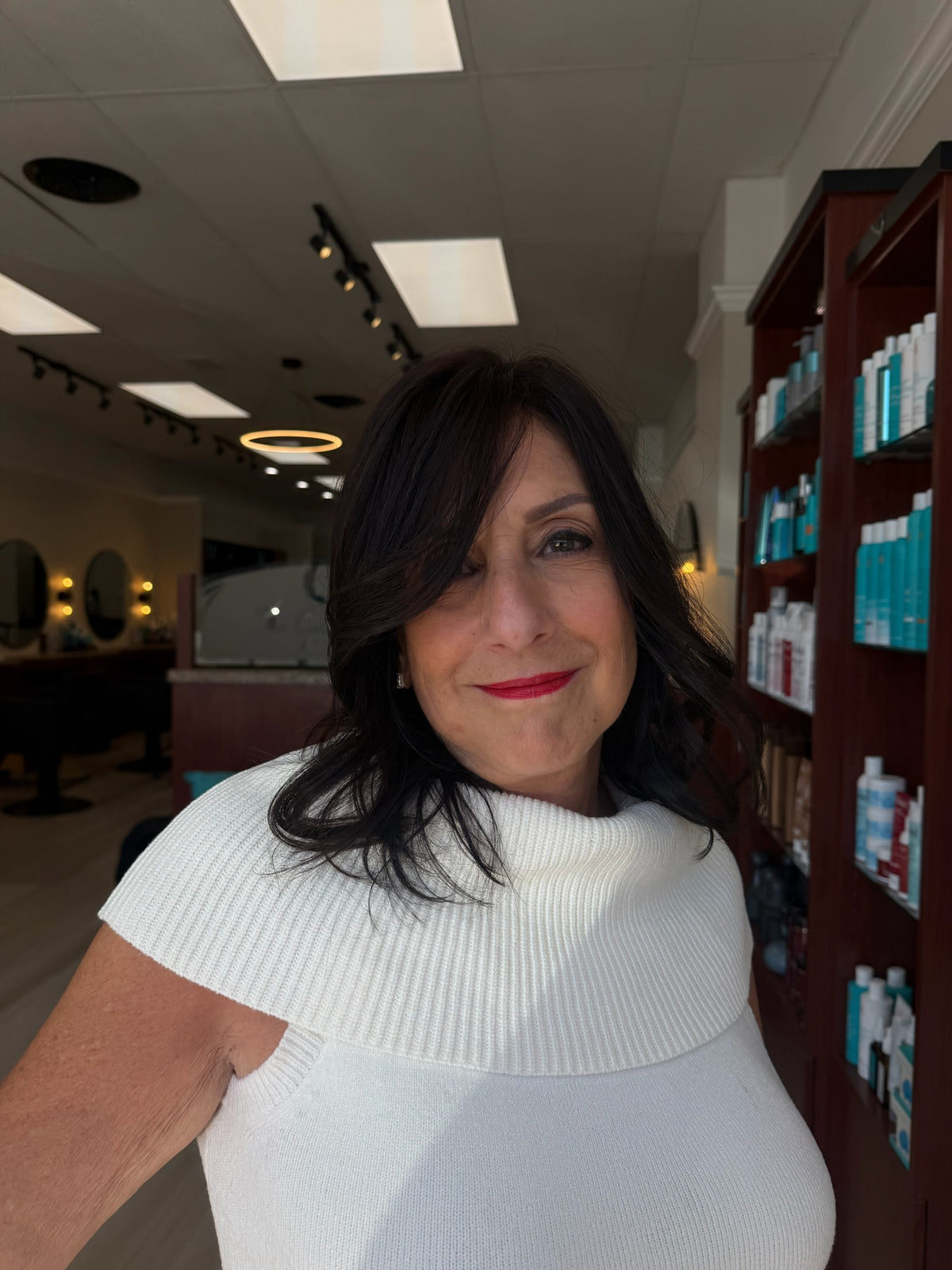 Full, voluminous dark hair after a mesh integration at The Cutting Edge Hair Design in Commack, NY