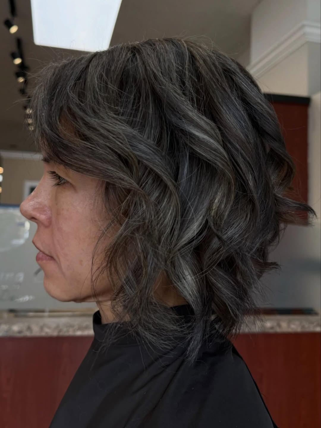 Moody dimensional color with lived-in waves at The Cutting Edge Hair Design, Commack NY
